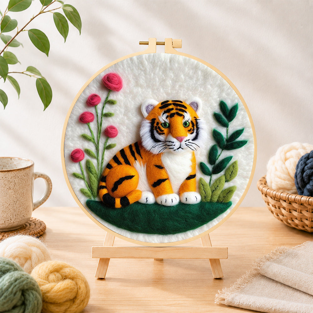 Finished charming little tiger needle felting displayed on a wooden easel