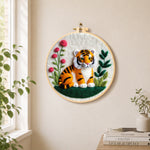Charming little tiger needle felt wall art displayed in a bright home interior