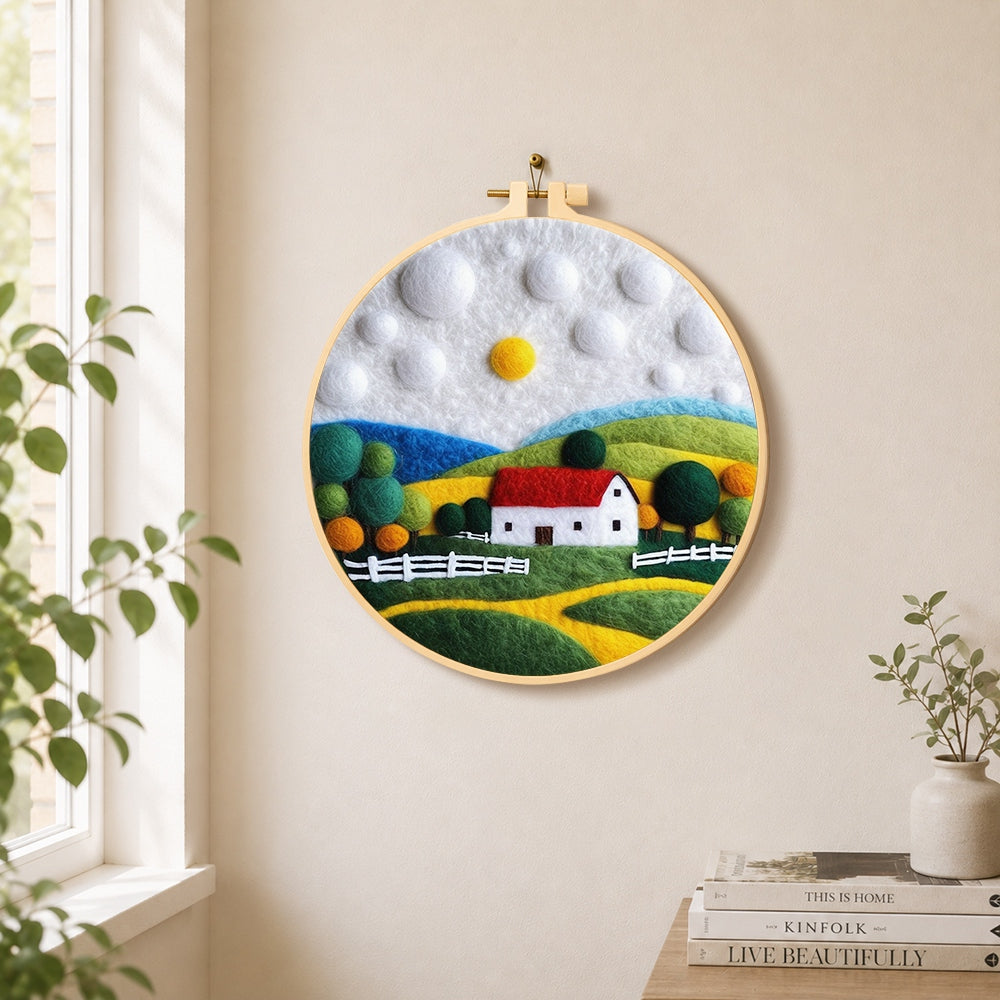 Charming red roof cottage needle felt wall art displayed in a bright home interior