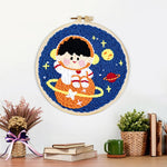 Finished charming space boy on orange planet artwork displayed on a wall