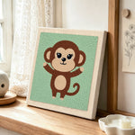 Cheerful monkey with open arms punch needle artwork displayed on a table