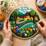 Creating the cheerful yellow cottages and blooming flowers wool painting by hand with a felting needle