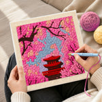 Creating handmade cherry blossom and red pagoda punch needle artwork