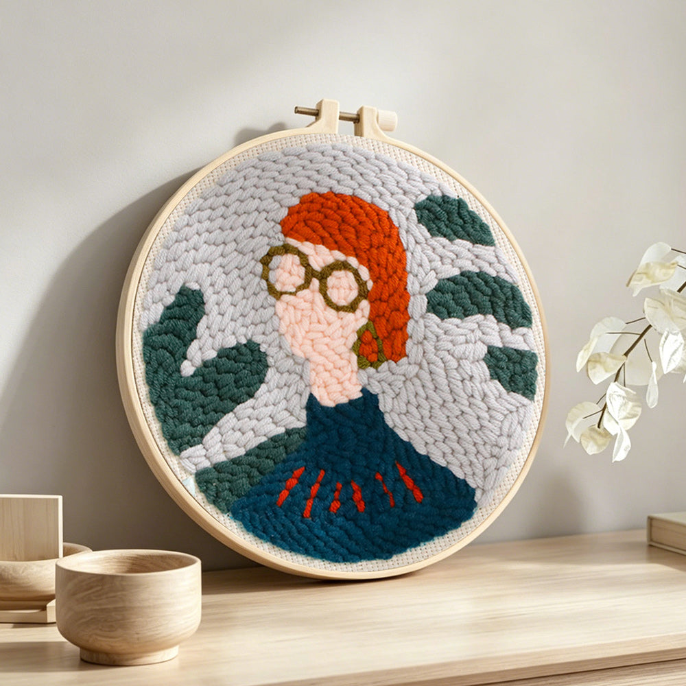 Chic boho lady with glasses punch needle artwork displayed on a table