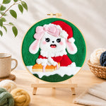 Finished christmas bunny with gift needle felting displayed on a wooden easel