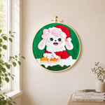 Christmas bunny with gift needle felt wall art displayed in a bright home interior