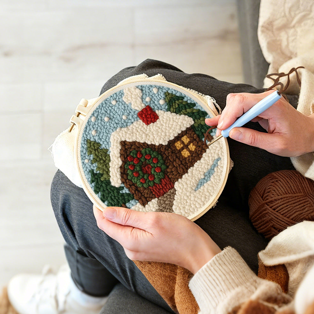 Creating handmade christmas cabin with wreath and smoke punch needle artwork