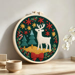 Christmas decorations and reindeer punch needle artwork displayed on a table