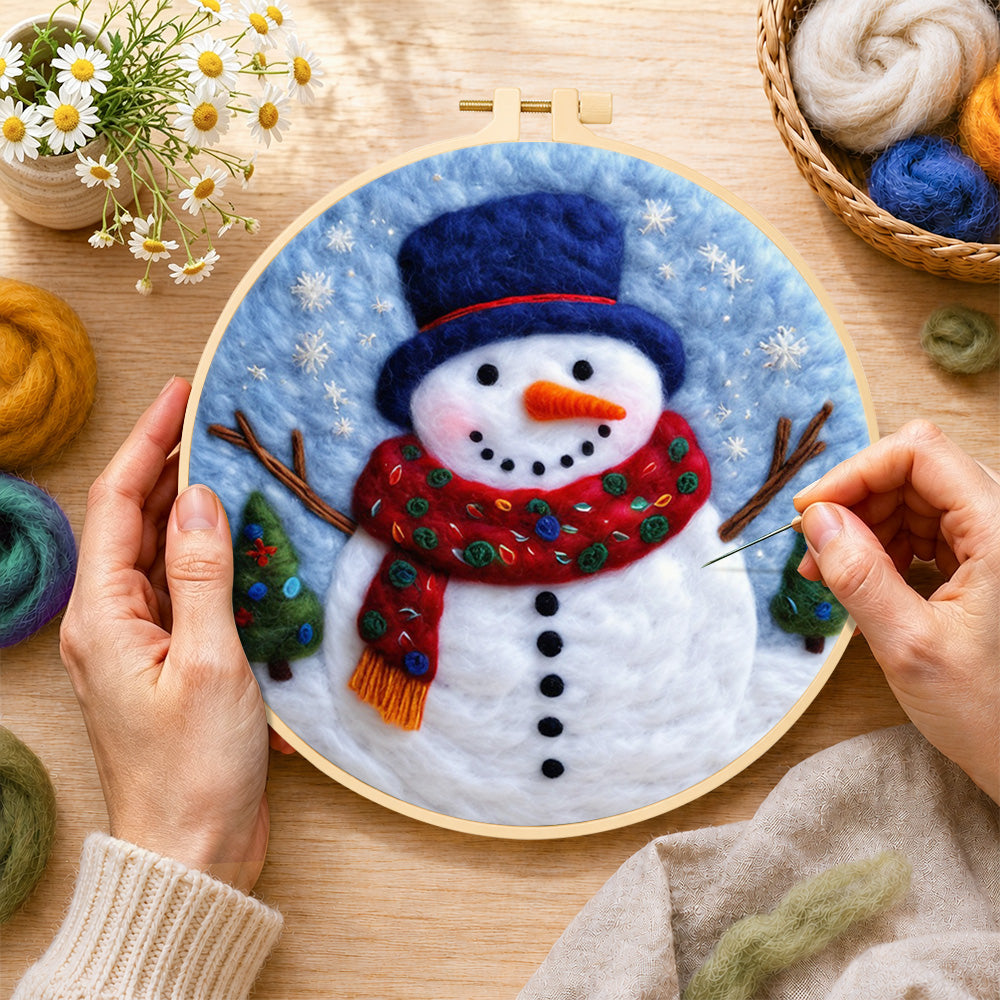 Creating the christmas snowman with blue top wool painting by hand with a felting needle