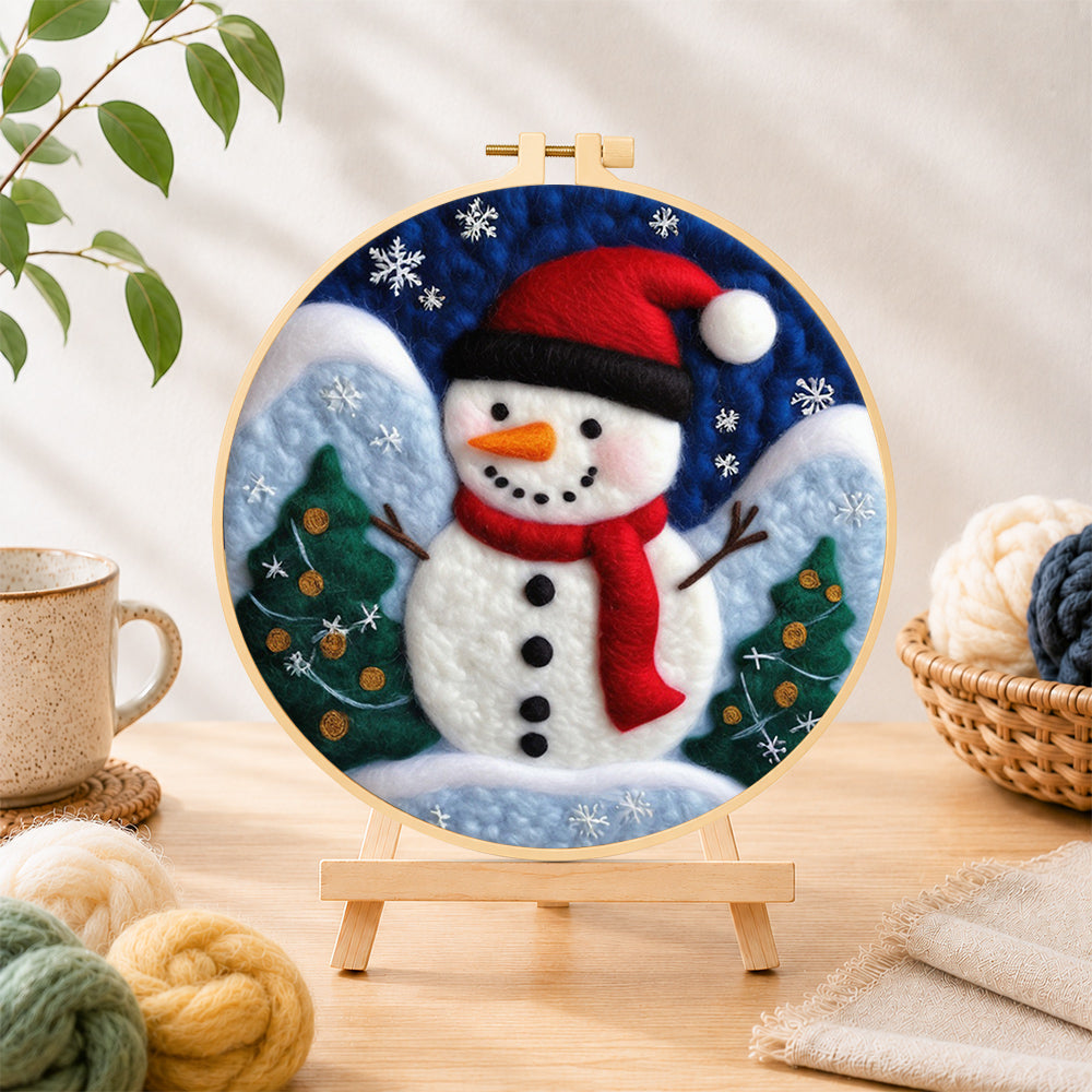 Finished christmas snowman with red scarf needle felting displayed on a wooden easel