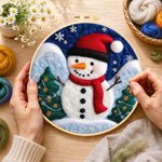 Creating the christmas snowman with red scarf wool painting by hand with a felting needle