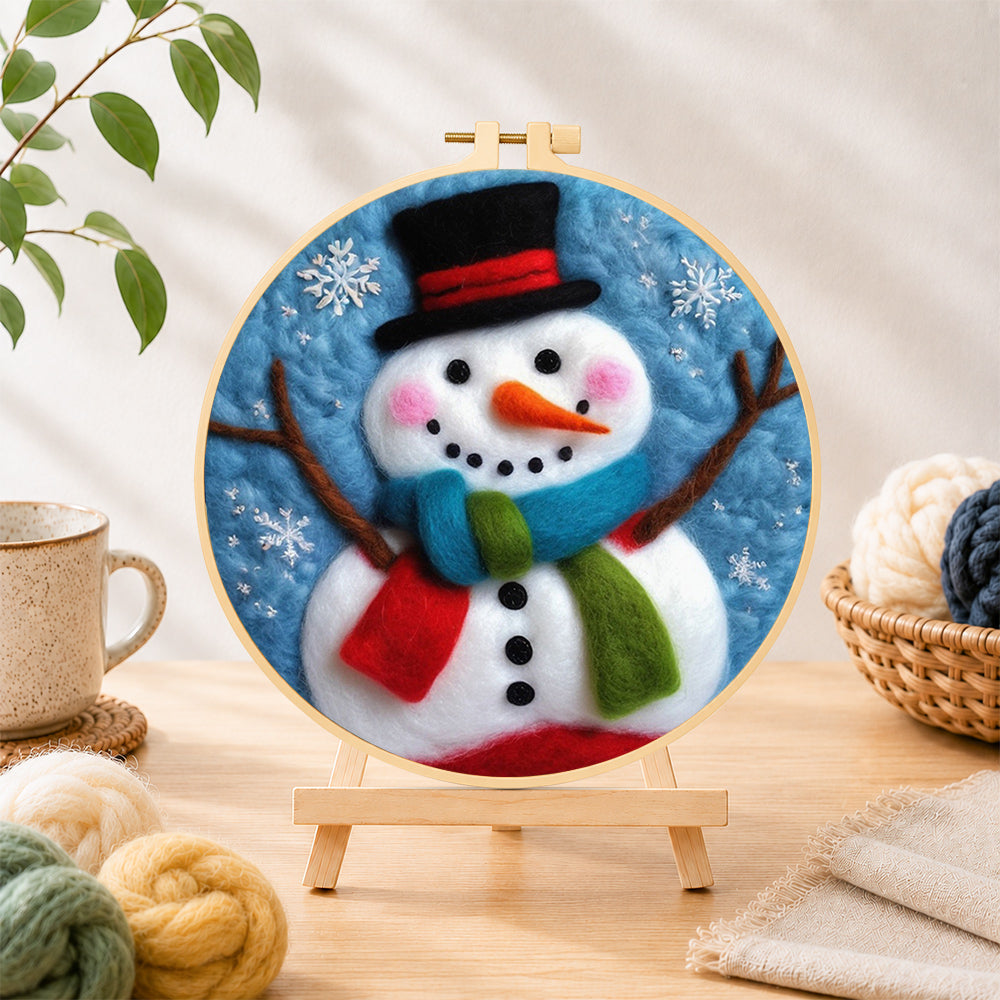 Finished christmas snowman with striped scarf needle felting displayed on a wooden easel