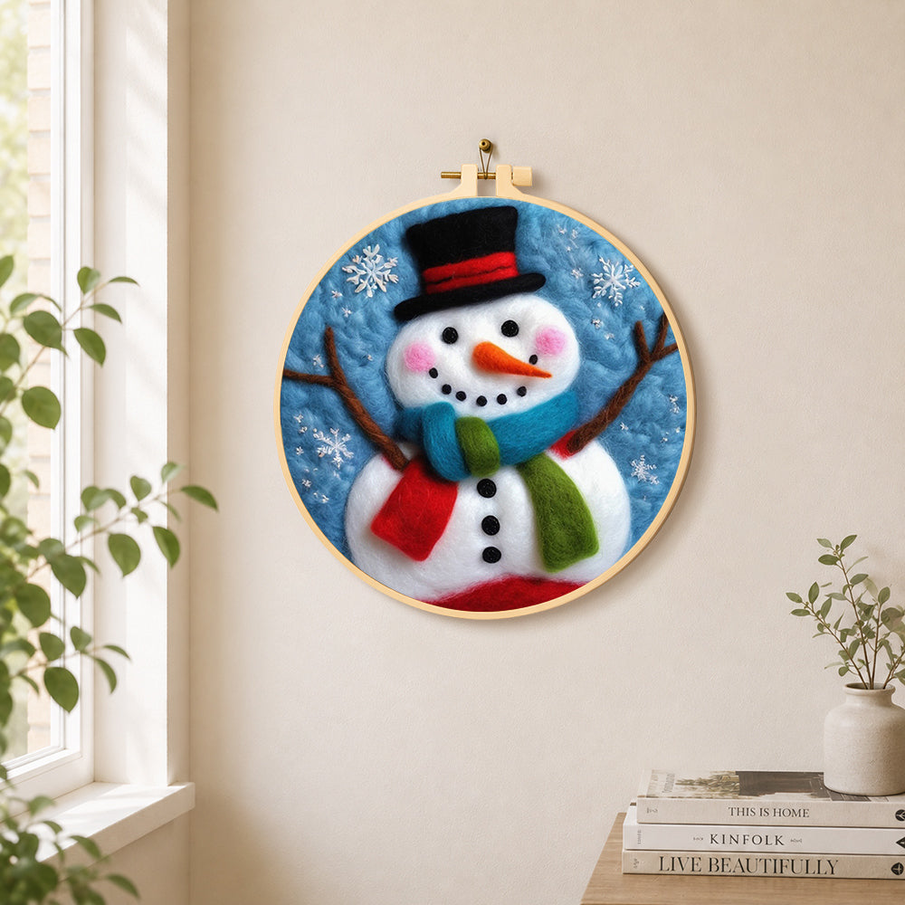 Christmas snowman with striped scarf needle felt wall art displayed in a bright home interior