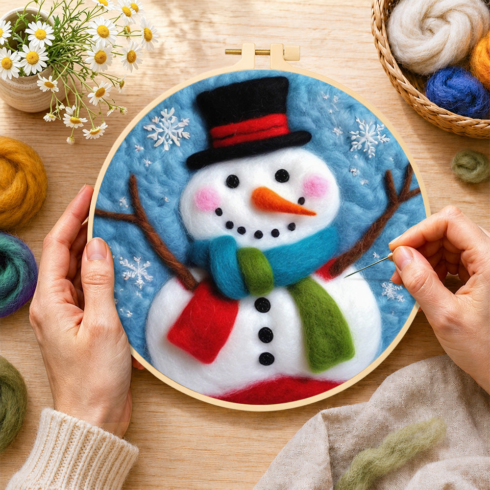 Creating the christmas snowman with striped scarf wool painting by hand with a felting needle