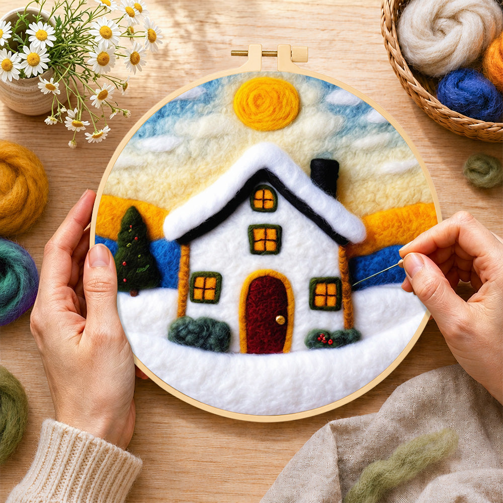 Creating the christmas snowy cottage wool painting by hand with a felting needle