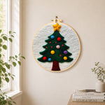 Christmas tree with colourful baubles needle felt wall art displayed in a bright home interior