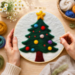 Creating the christmas tree with colourful baubles wool painting by hand with a felting needle