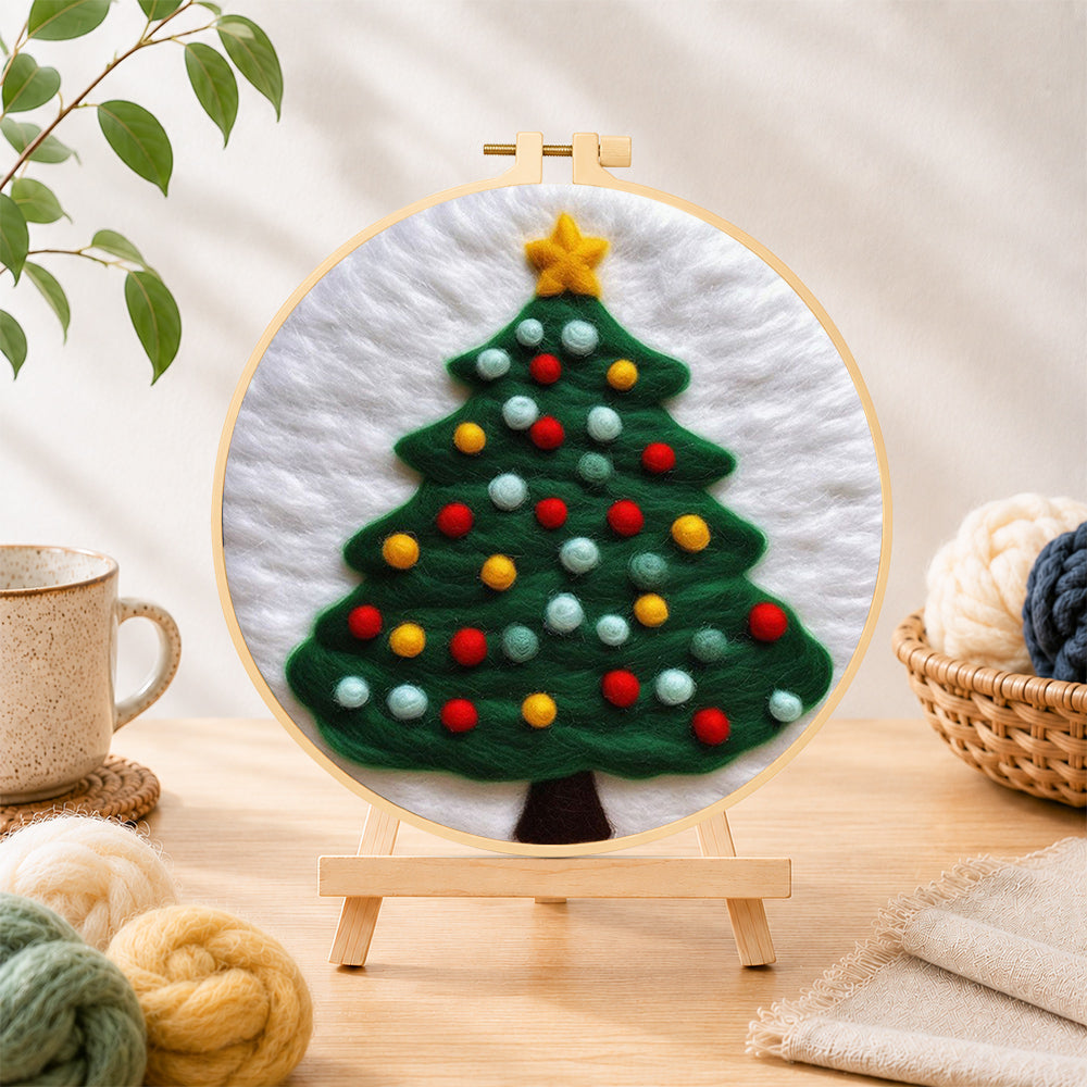 Finished christmas tree with lots of bright baubles needle felting displayed on a wooden easel