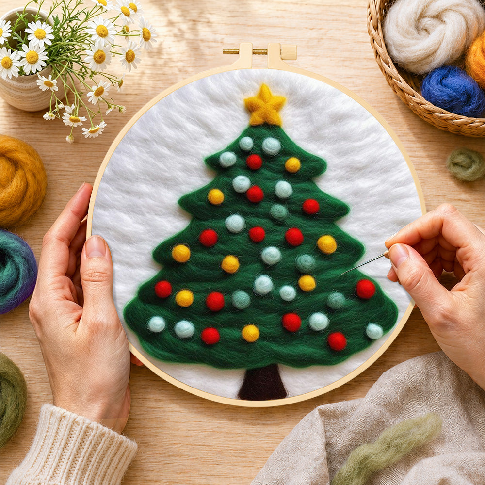 Creating the christmas tree with lots of bright baubles wool painting by hand with a felting needle