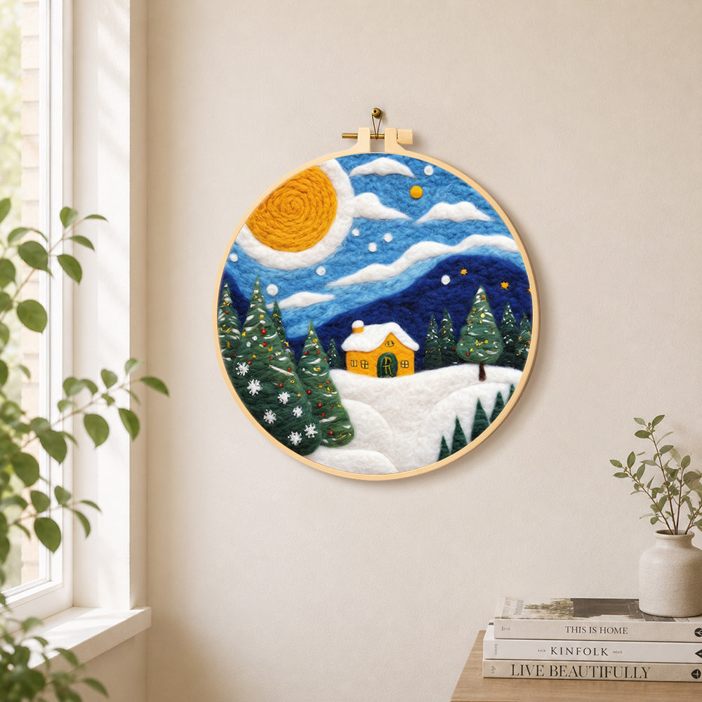 Christmas trees and a yellow cottage needle felt wall art displayed in a bright home interior
