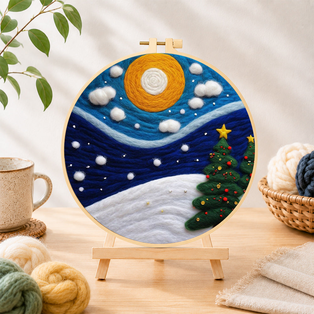 Finished christmas trees under the moon needle felting displayed on a wooden easel