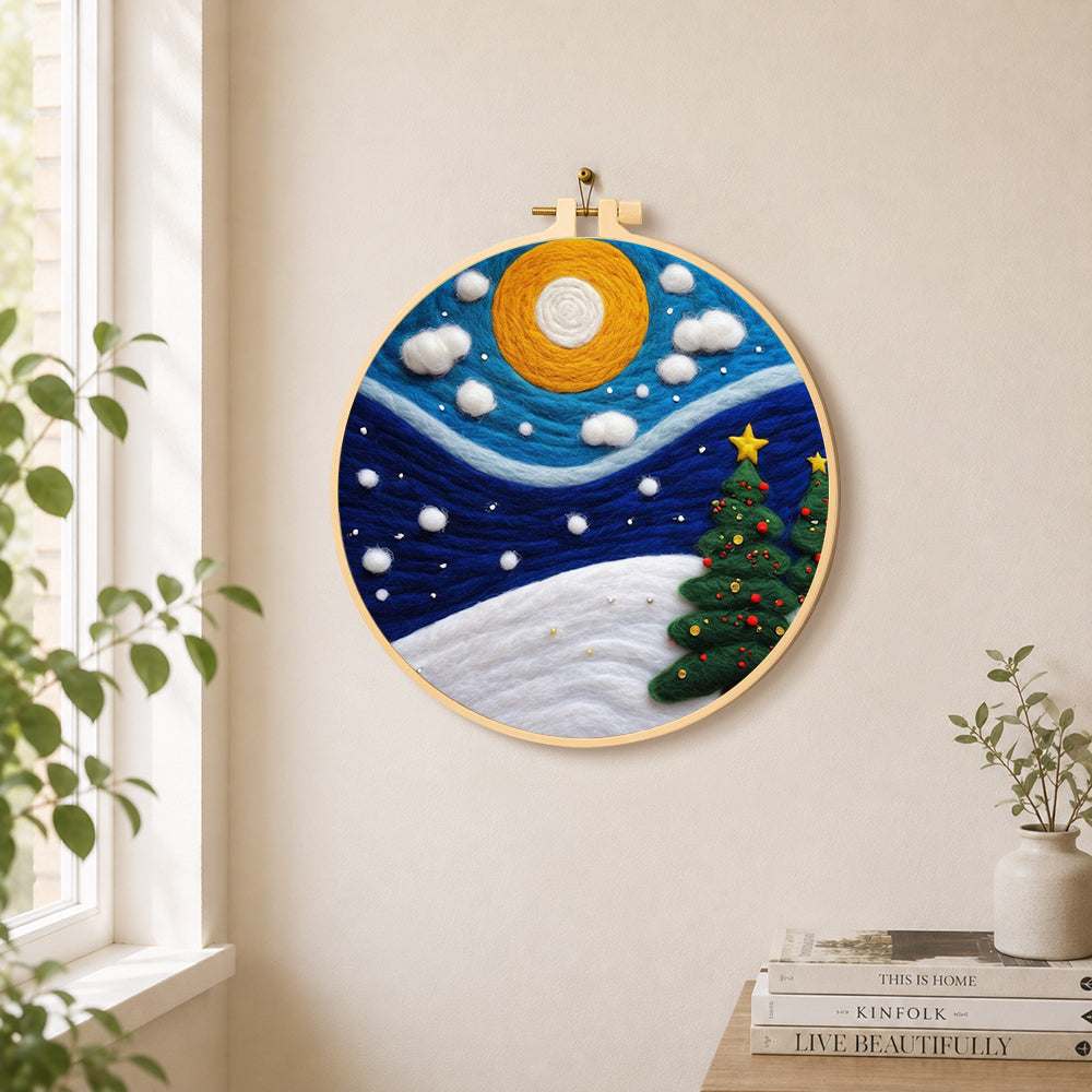 Christmas trees under the moon needle felt wall art displayed in a bright home interior