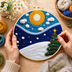 Creating the christmas trees under the moon wool painting by hand with a felting needle