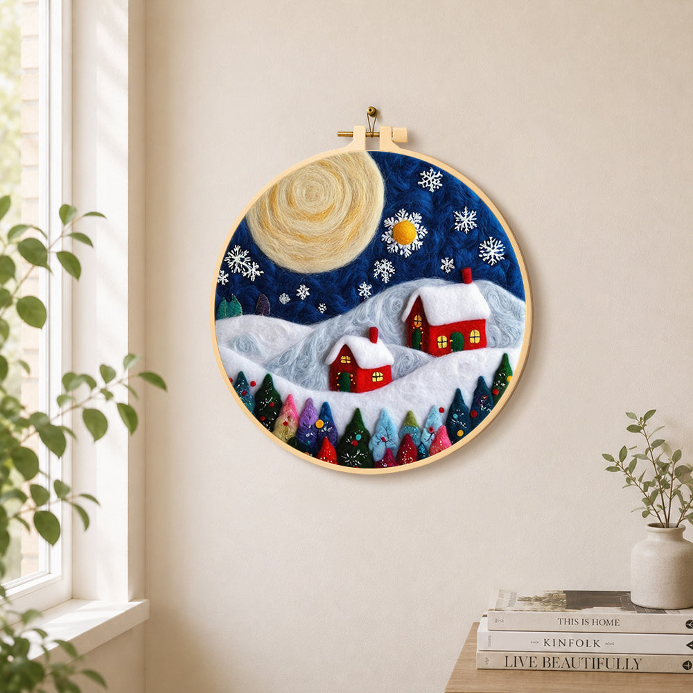 Christmas village with big moon needle felt wall art displayed in a bright home interior