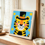 Circus tiger with stars and hat punch needle artwork displayed on a table