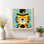 Finished circus tiger with stars and hat artwork displayed on a wall