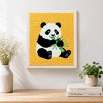 Finished classic panda eating bamboo artwork displayed on a wall