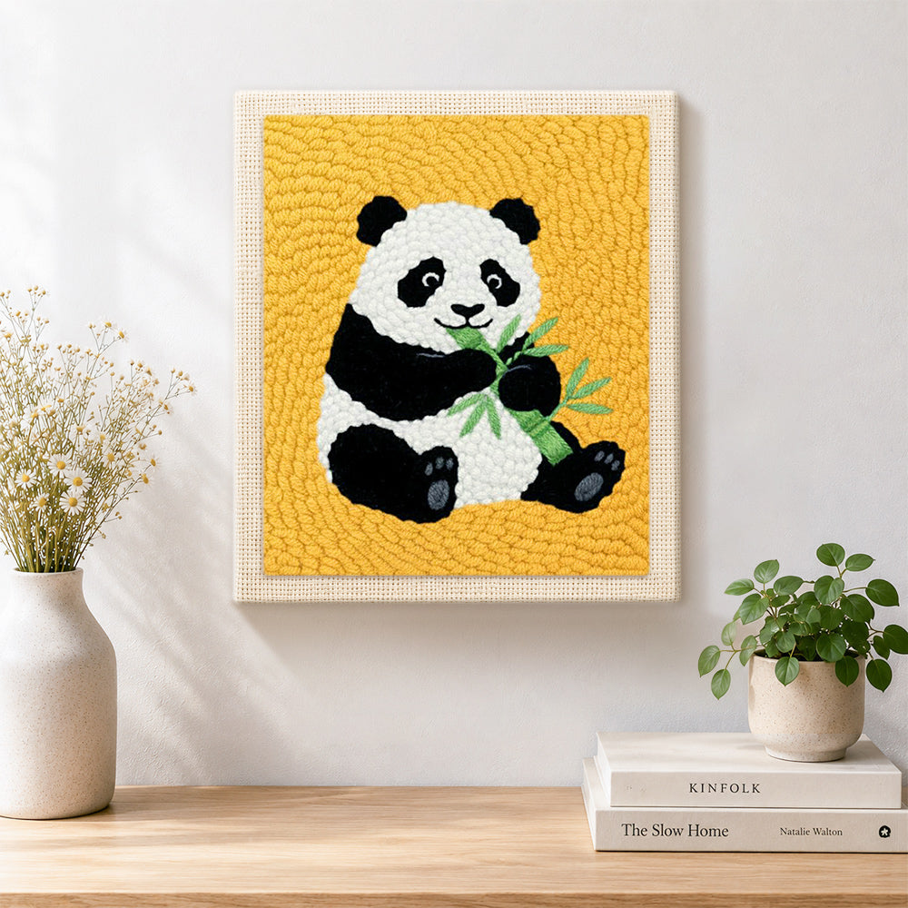 Finished classic panda eating bamboo artwork displayed on a wall