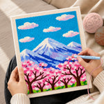 Creating handmade cloudy sakura mountain punch needle artwork