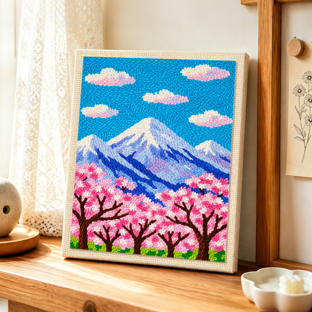 Cloudy sakura mountain punch needle artwork displayed on a table