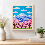 Finished cloudy sakura mountain artwork displayed on a wall