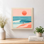 Finished coastal surfer and peach sunset scene artwork displayed on a wall