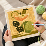 Creating handmade cocktail with green leaves and lime punch needle artwork
