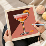 Creating handmade cocktail with ice and orange slice punch needle artwork