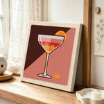 Cocktail with ice and orange slice punch needle artwork displayed on a table