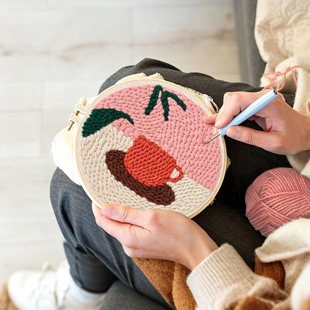 Creating handmade coffee cup and leaf punch needle artwork