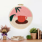 Finished coffee cup and leaf artwork displayed on a wall