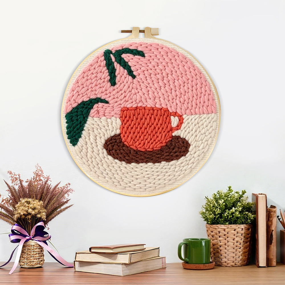 Finished coffee cup and leaf artwork displayed on a wall