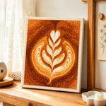 Coffee with leaf pattern latte art punch needle artwork displayed on a table
