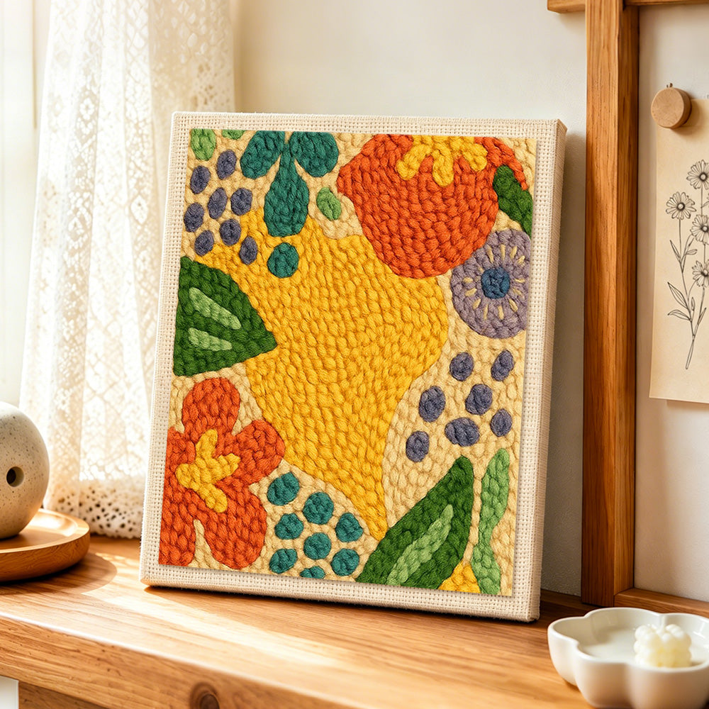 Colourful abstract botanical punch needle artwork displayed on a table