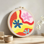 Colourful abstract flowers punch needle artwork displayed on a table