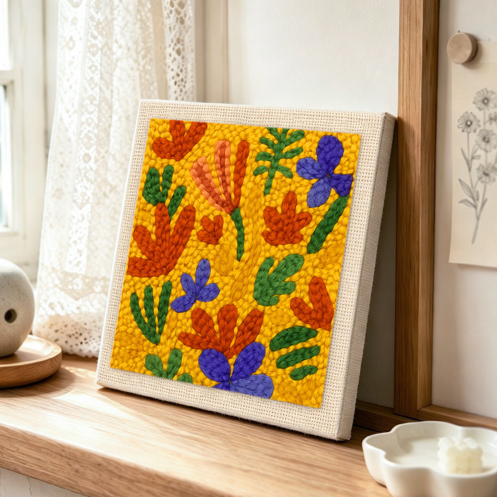 Colourful abstract petals punch needle artwork displayed on a table