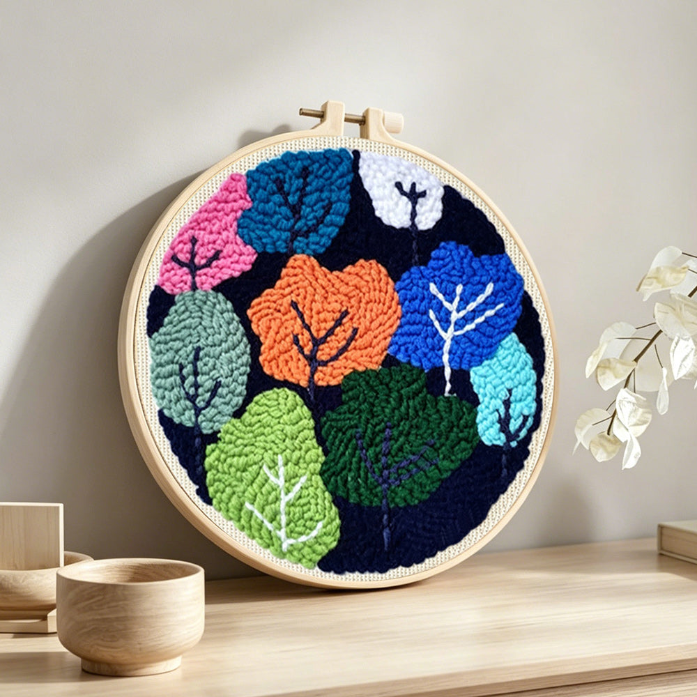 Colourful abstract trees punch needle artwork displayed on a table