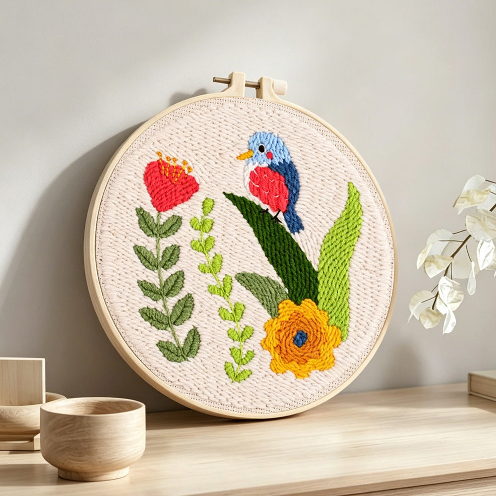 Colourful bird and flowers punch needle artwork displayed on a table