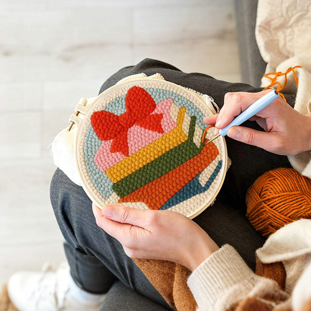 Creating handmade colourful book stack with bow punch needle artwork