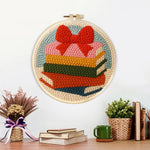 Finished colourful book stack with bow artwork displayed on a wall